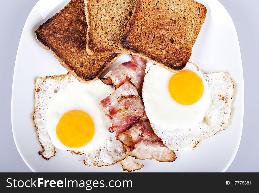 Breakfast - roasted toasts, eggs, bacon. Breakfast - roasted toasts, eggs, bacon