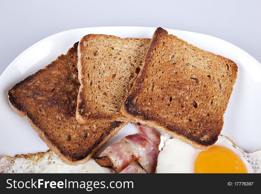 Breakfast - toasts, eggs, bacon