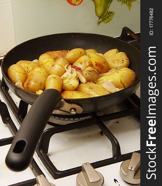 Potatoes being fried in a pan. Potatoes being fried in a pan
