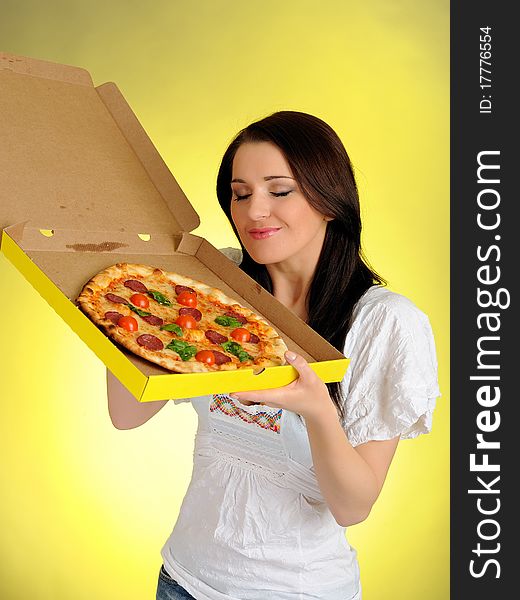 Pretty young casual girl with tasty pizza in delivery paper box. isolated on white background. Pretty young casual girl with tasty pizza in delivery paper box. isolated on white background