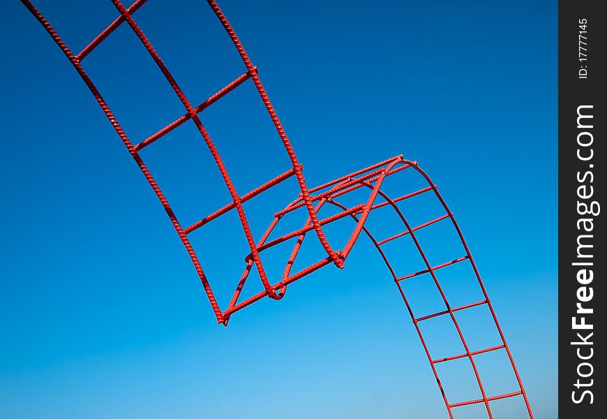 Bending steel painted red and blue sky background