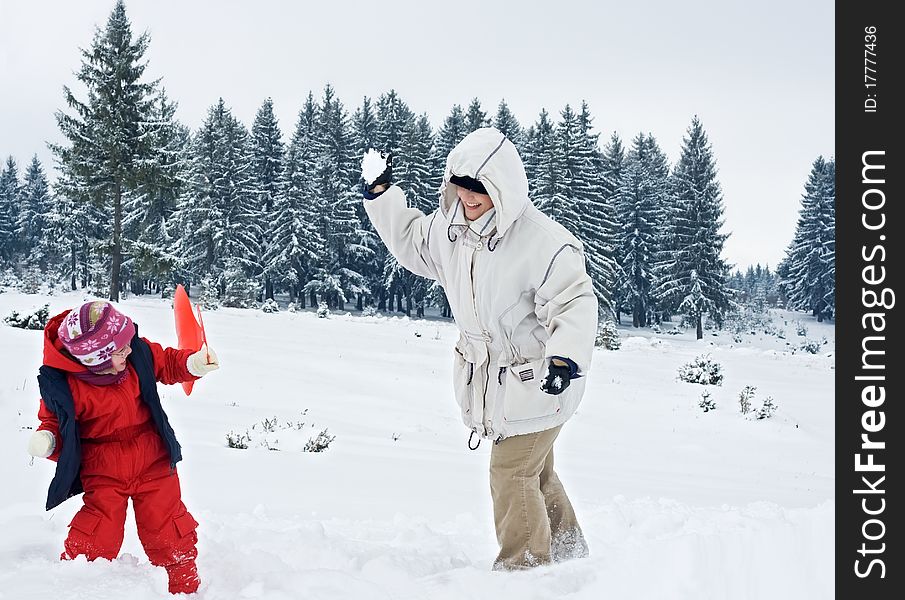 Happy woman playing with her daughter outdoor