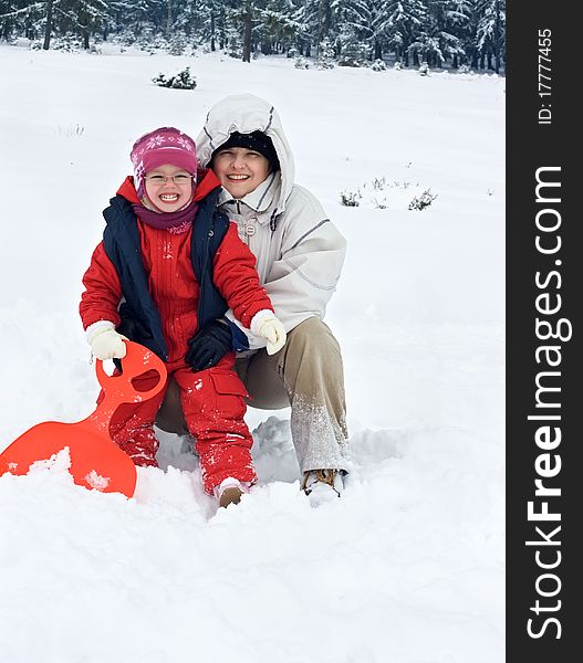 Happy woman with her daughter in winter time