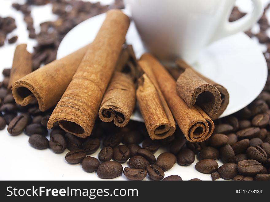 coffee beans and cinnamon sticks on white. coffee beans and cinnamon sticks on white