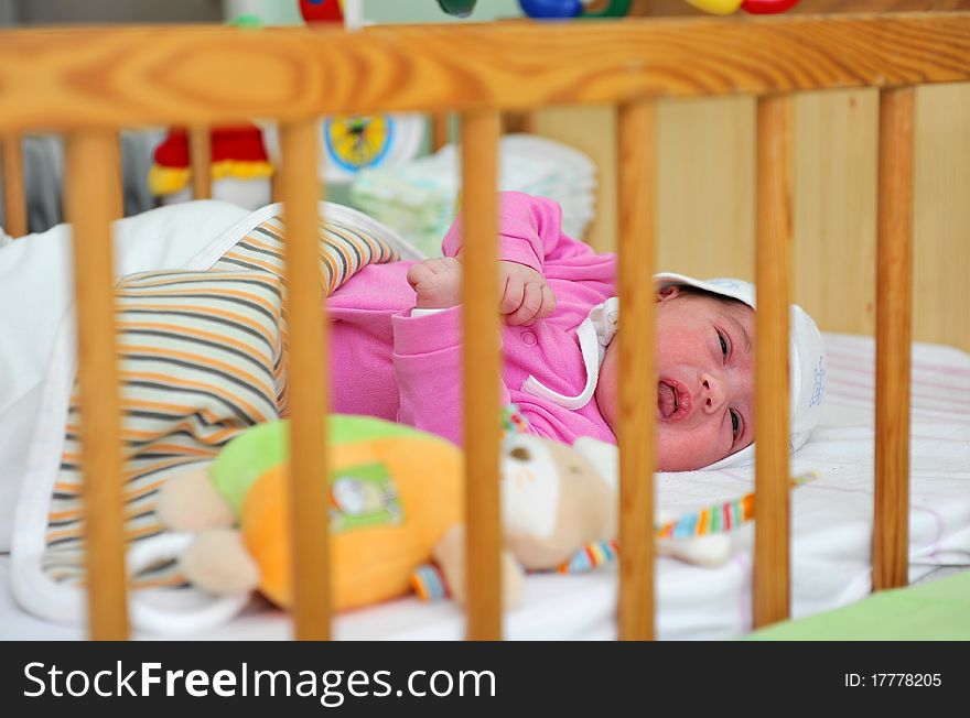 Little girl sleeping in cot