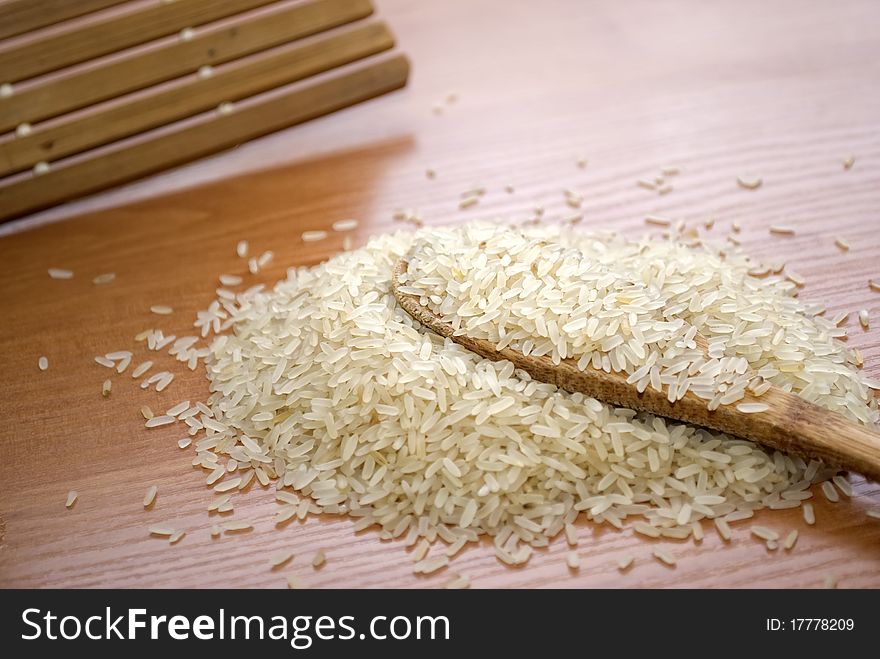 Rice grits, rice grits in a wooden spoon