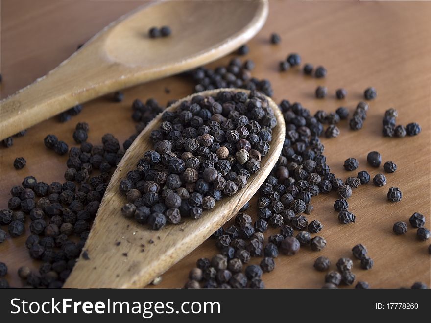 black pepper in a wooden spoon