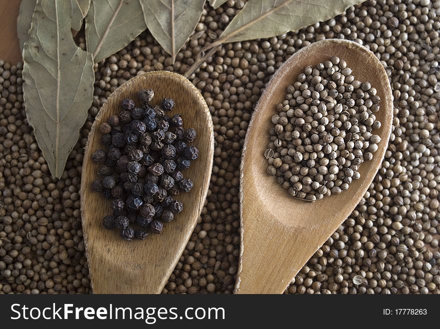 black pepper in a wooden spoon