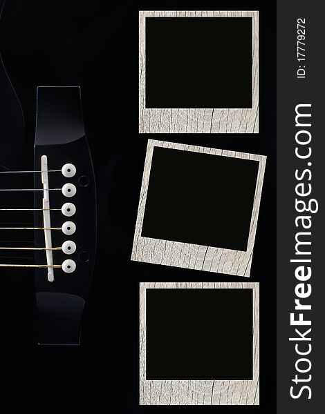 Guitar with picture frame on a black background.