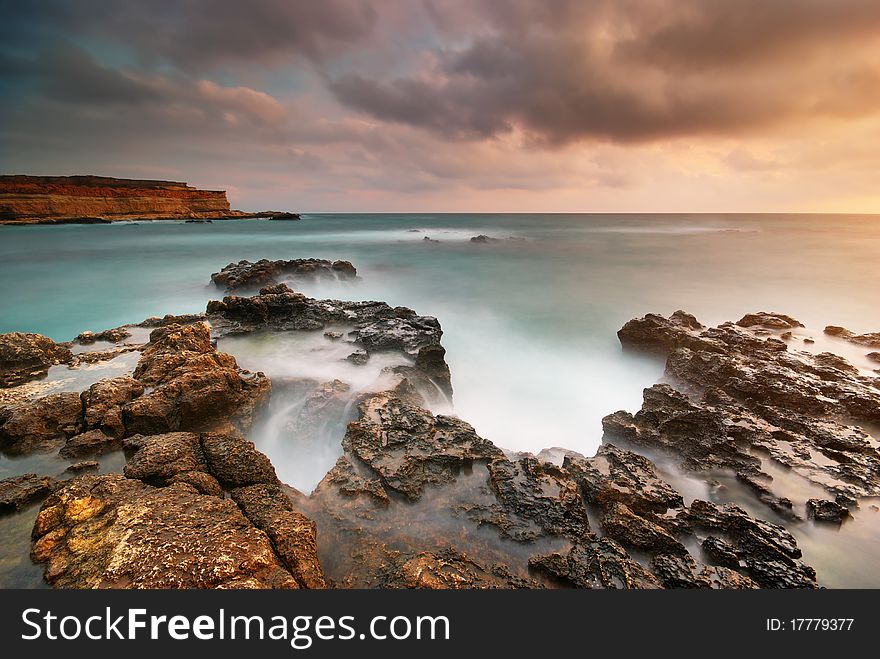 Beautiful seascape. Sea and rock at the sunset. Nature composition.