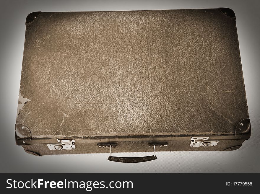 Vintage suitcase in sepia on white background