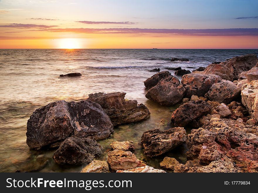 Beautiful seascape. Sea and rock at the sunset. Nature composition.