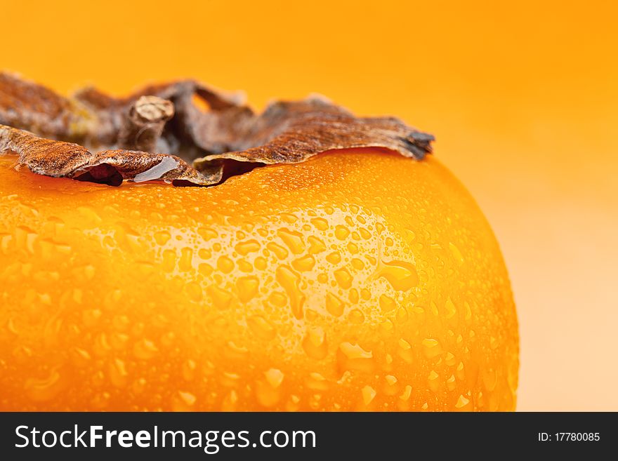 Persimmon fruit with drops of water