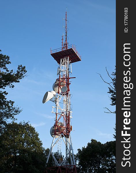 Huge communication antenna surrounded by trees. Huge communication antenna surrounded by trees.