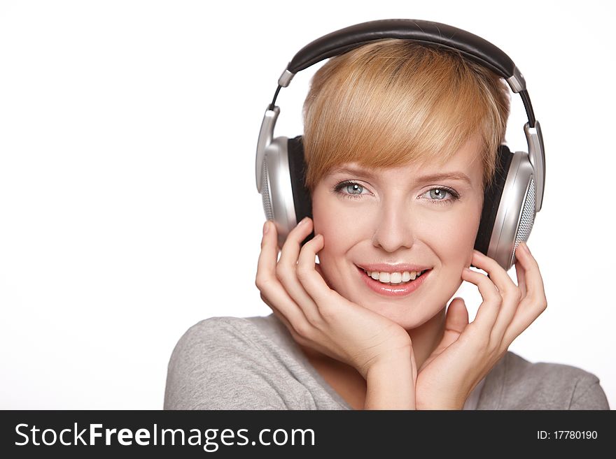 Closeup of a pretty blond female listening to music over headphones. Closeup of a pretty blond female listening to music over headphones