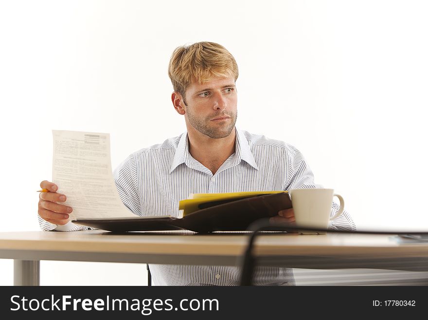 Businessman reading and writing at desk. Businessman reading and writing at desk