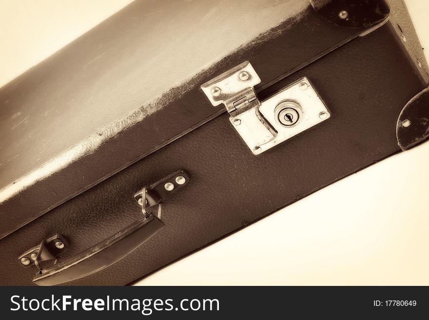 Vintage suitcase in sepia on white background