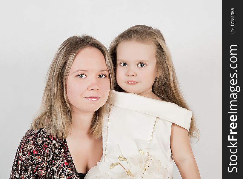 Beautiful young mother and her three year old daughter at studio. Beautiful young mother and her three year old daughter at studio