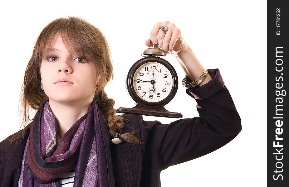 Portrait of the beautiful teenage girl with old alarm clock on a white background.
