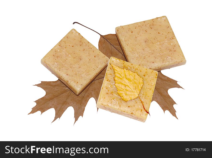 Three bars of natural soap with leaves on a white. Three bars of natural soap with leaves on a white