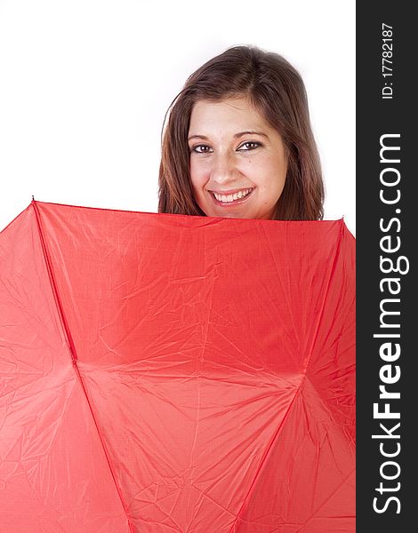 A woman is peaking over a red umbrella and smiling. A woman is peaking over a red umbrella and smiling.