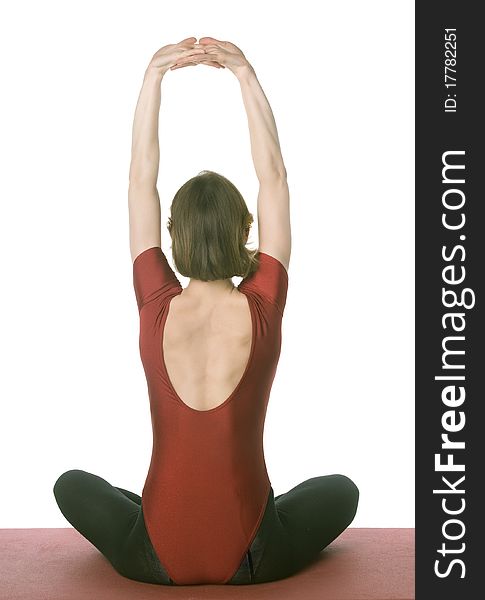 Woman exercising on a mat over white background. Woman exercising on a mat over white background