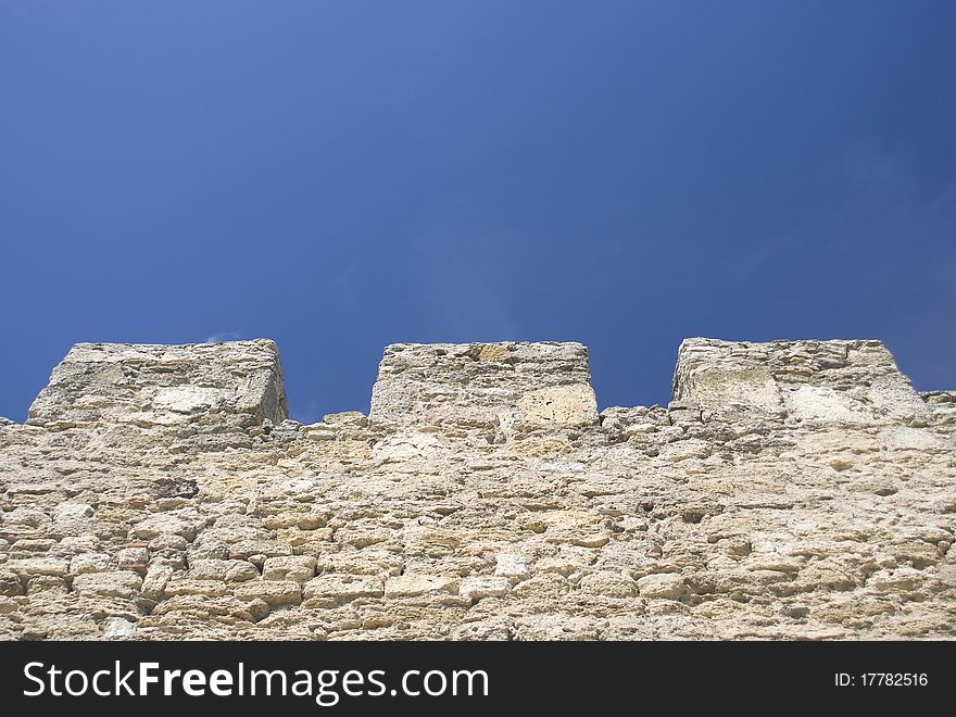 Merlons of an old fortress wall in a sunny day