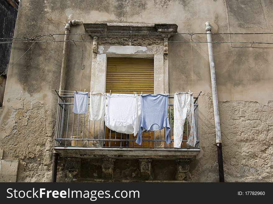 Old building in Italy  with clothes near window, on anciient balcony