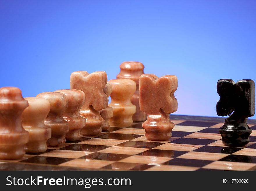 Marble chess on chessboard with light blue background