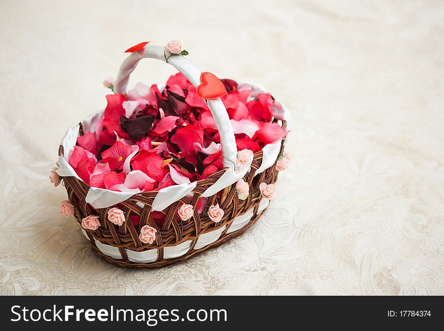 Bunch of fresh red petals in basket for wedding ceremony