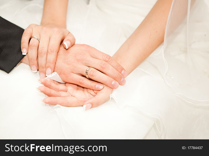 Closeup of two hands of caucasian young adults with wedding rings. Closeup of two hands of caucasian young adults with wedding rings