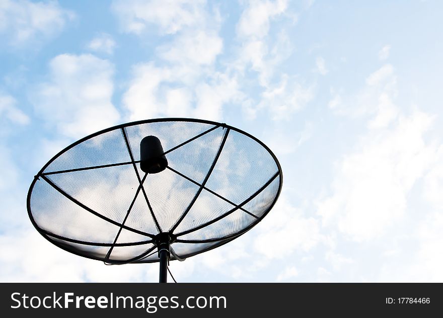 Satellite Dish on roof over blue sky background