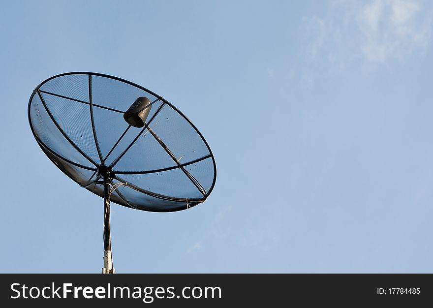 Satellite Dish on roof over blue sky background