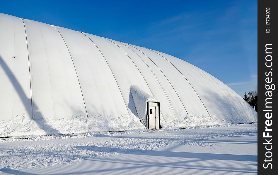 Sports arena protected by inflated dome. Sports arena protected by inflated dome