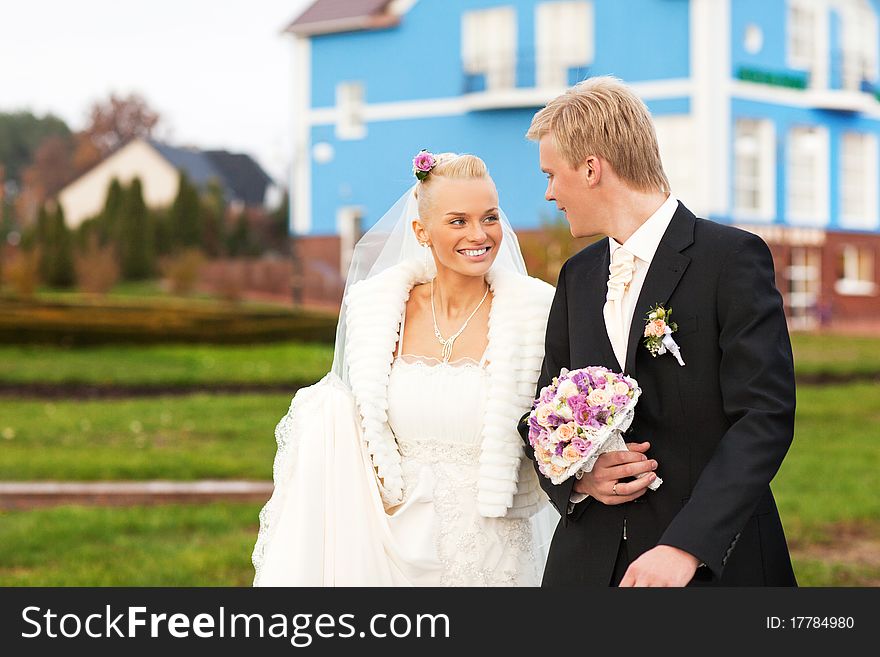 Beautiful just married caucasian couple walking and smiling. Beautiful just married caucasian couple walking and smiling