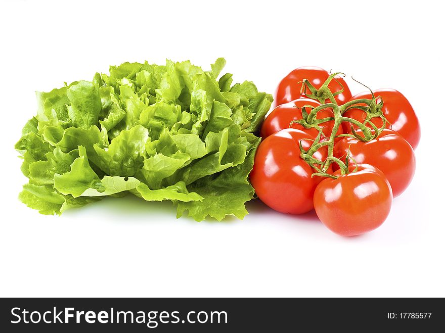 Fresh tomatoes and lettuce isolated over white background