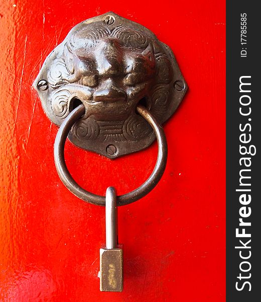 Red chinese door with a lion head