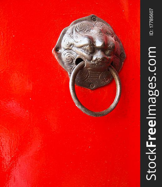 Red chinese door with a lion/dragon head