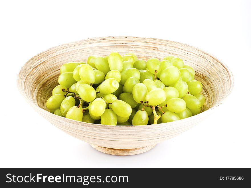 Grape fruits in wooden bowl - isolated over white. Grape fruits in wooden bowl - isolated over white