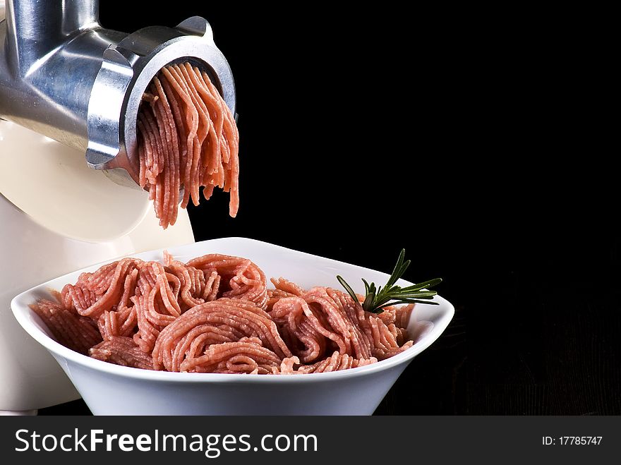 Bowl of mince with electric meat grinder. Bowl of mince with electric meat grinder