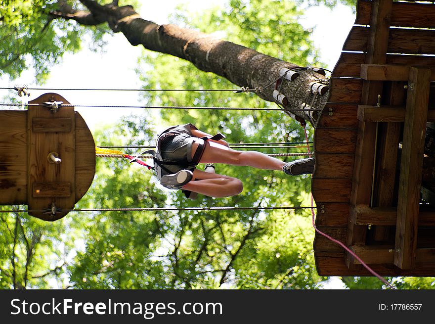 Woman jumps high up on a wooden platform. Woman jumps high up on a wooden platform