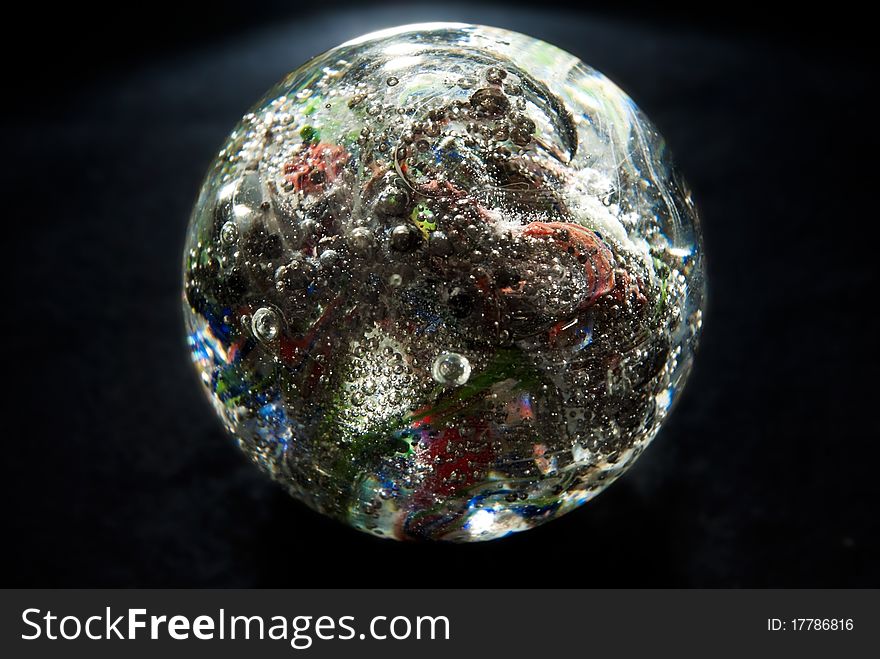 Crystal glowing sphere with bubbles, on black