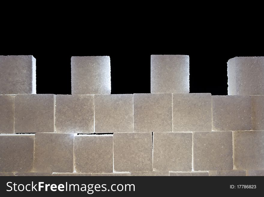 A wall with castellation made from sugar cubes, backlight. A wall with castellation made from sugar cubes, backlight