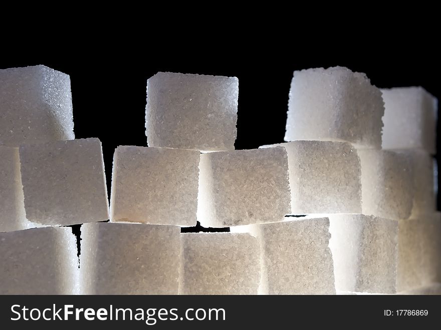 A top of tower made from sugar cubes, backlight. A top of tower made from sugar cubes, backlight