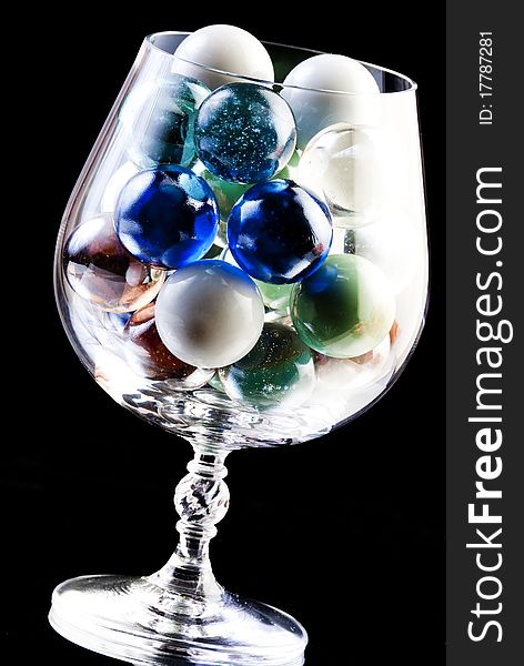 Snifter filled with colored glass balls. Snifter filled with colored glass balls