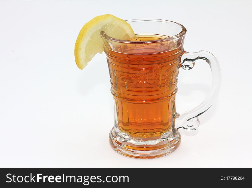 Cup of tea with a slice of lemon in a clear glass