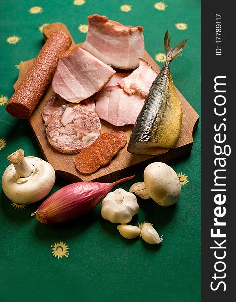 Assortment of meat appetizers on green tablecloth