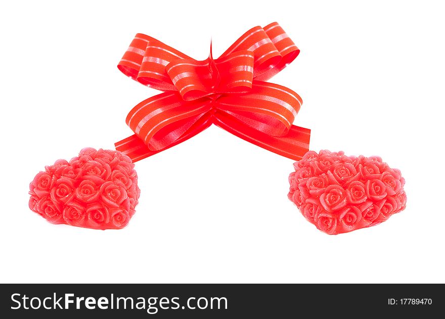 Two red hearts and bow isolated on white background