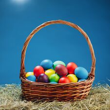 Easter Basket With Multicolor Eggs, Blue Background Stock Image