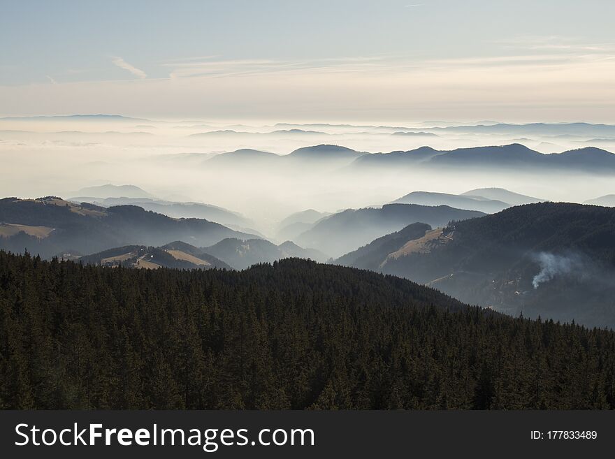 View over Rogla shot from the Tree Tops Walk. Beautiful view of the cloudy skyes and forest in Pohorje in Slovenia. Popular tourist attraction and viewpoint.